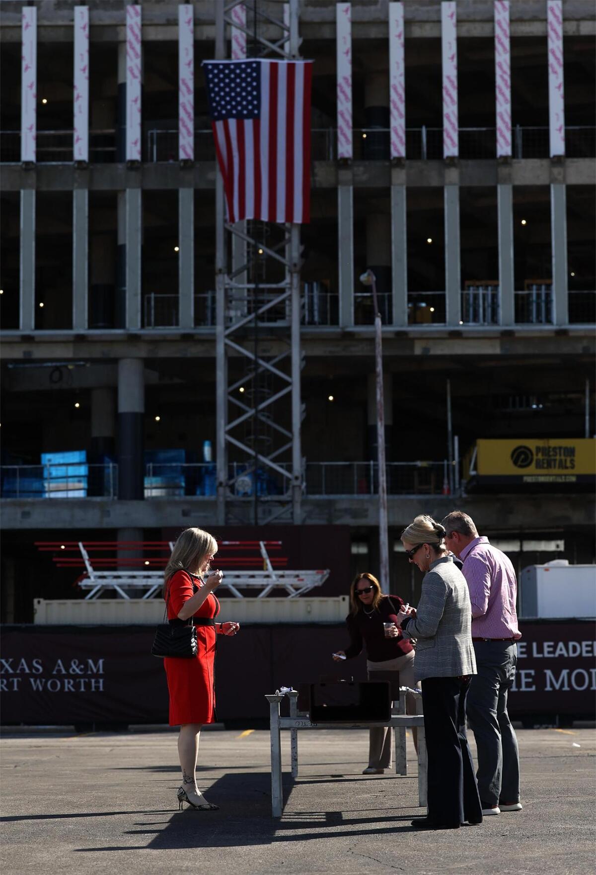 Guests sign their name to the final beam during topping out ceremony for the Texas A&M-Fort Worth Law and Education Building currently under construction on Monday, Nov. 11, 2024.